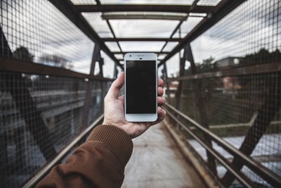 Holding a white smartphone
